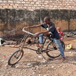 kid with bicycle in rescue centre yard